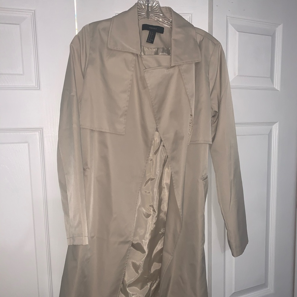 Tan colored trench coat with pockets